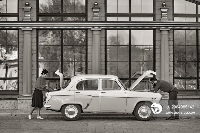 Couple in love near the car in retro style