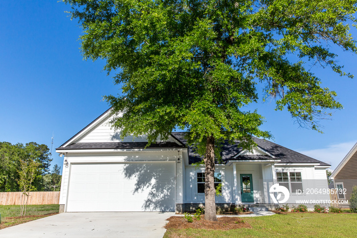 Exterior facade of a white new construction farmhouse style small house