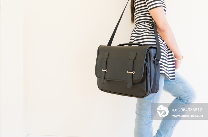 Woman carrying a black leather bag