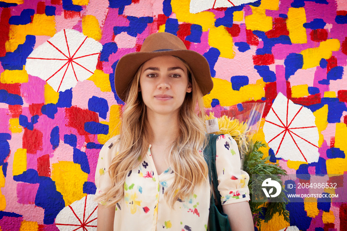 Portrait f young woman against colorful wall