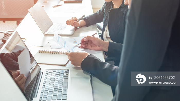 Businessman and woman discussing on stockmarket charts in office