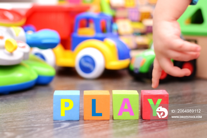 Little baby hand playing with colorful toys and cubes