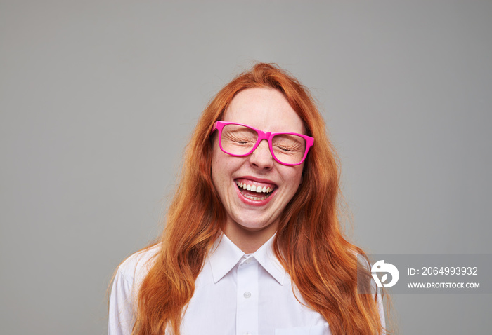 Positive red hair teenager girl laughing