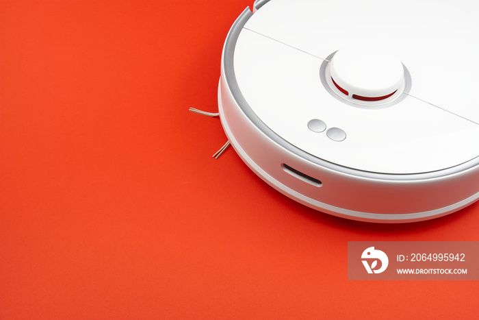 robot vacuum cleaner isolated on red background, close up photo. close up photo