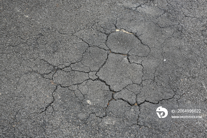 Cracked asphalt background.