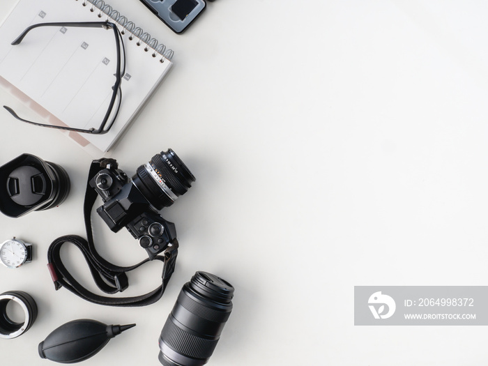 top view of work space photographer with digital camera, flash, cleaning kit, memory card and camera