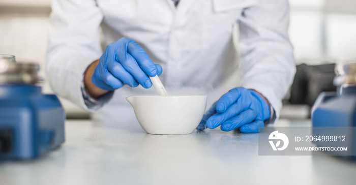 Chemist performs an experiment with liquid nitrogen