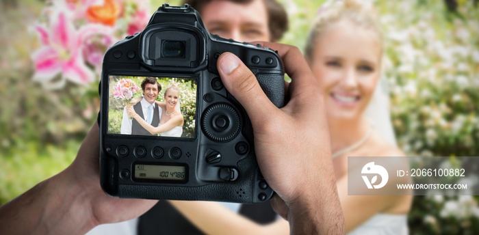 Composite image of cropped image of hands holding camera