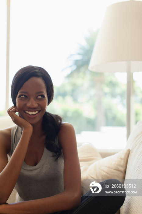 Portrait happy mischievous young woman on sofa