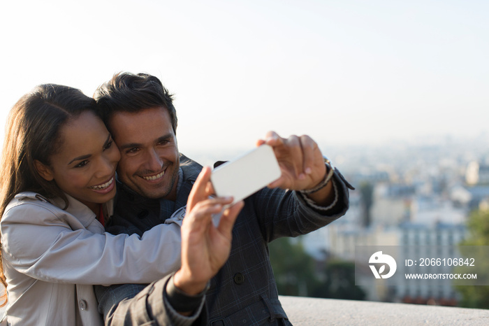 Happy couple taking selfie with camera phone