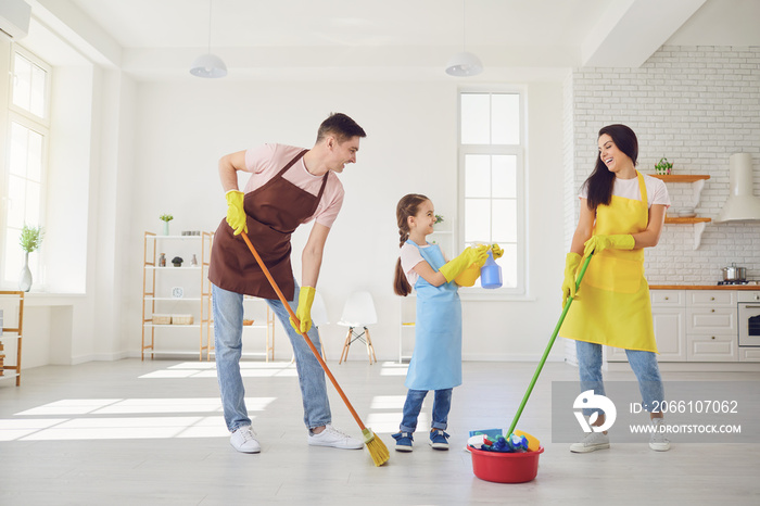 Happy family cleans the room in the house.