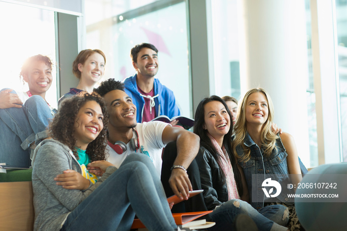 Happy diverse young college students in student lounge