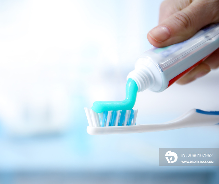 Toothbrush and toothpaste on blurred background