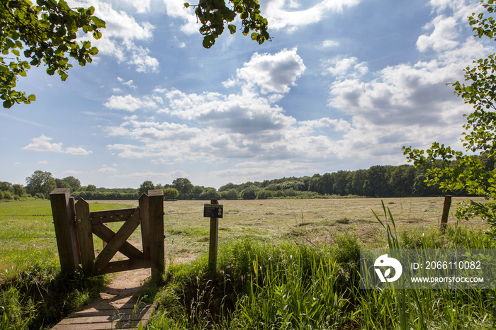 Small gate and fench at countryside. Achterhoek Netherlands. Entrance to walking track. Path.