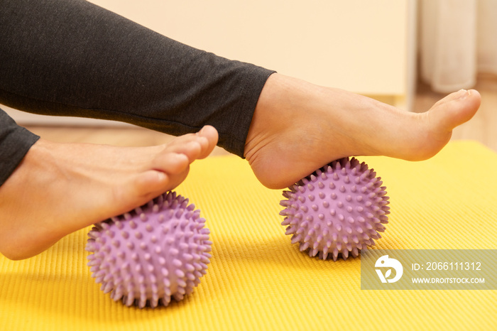 Female feet and prickly massage balls