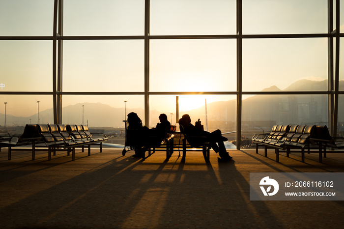 Passenger sitting in a lobby airport waiting for flight