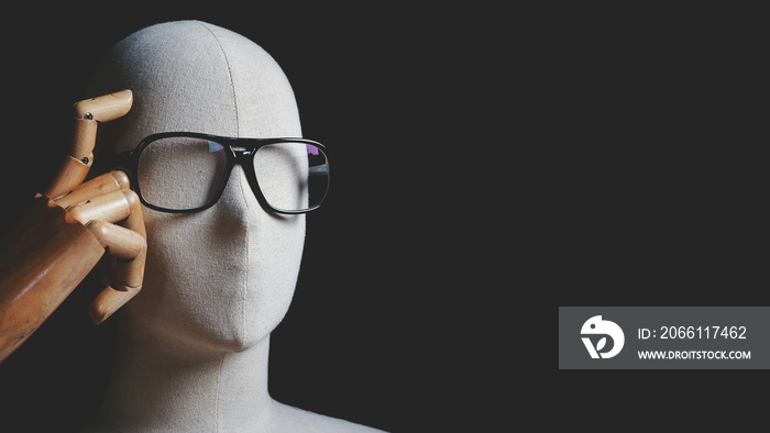 Close up white mannequin with eyeglasses in thinking and having idea gesture on black background