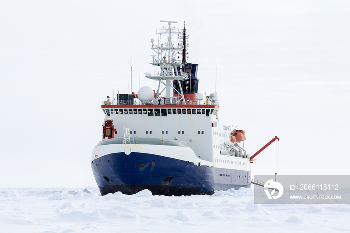 Research icebreaker docked over an ice floe