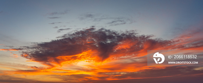 Panorama photo of dramatic sky with orange sunset and clouds