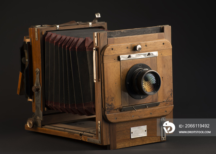 Old photographic camera on a dark gray background 1