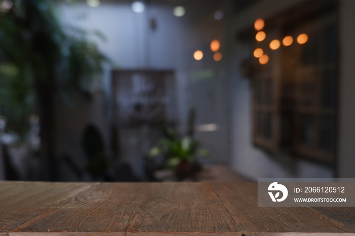 wood table in front of blurred cafe exterior