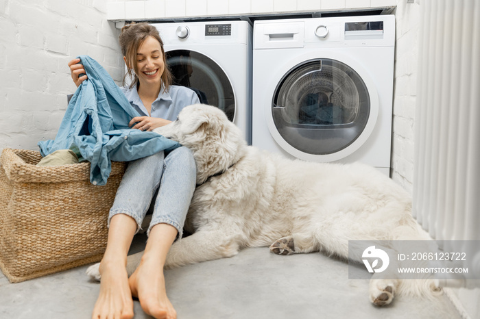 Woman with a dog doing housework in the laundry