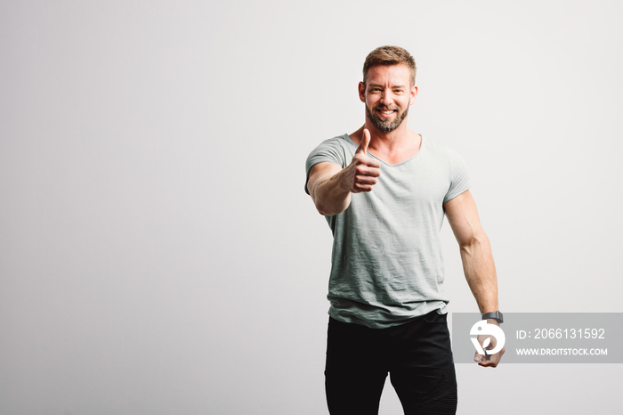 Happy man showing OK gesture and smiling