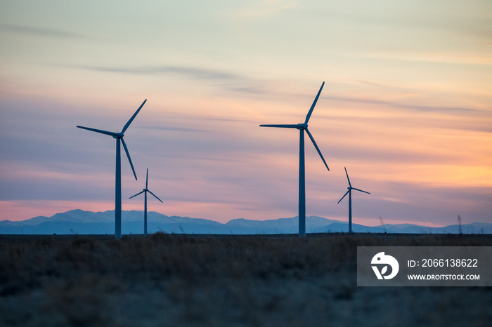 Silhouette of windmills against a sunset sky in Northern Colorado.