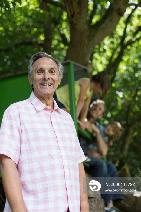 Portrait happy senior man with family in park