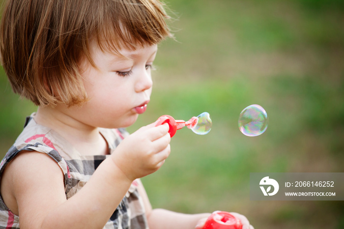 Close up of girl blowing bubbles in Prospect Park