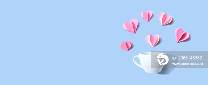 Coffee cup with paper craft hearts - flat lay