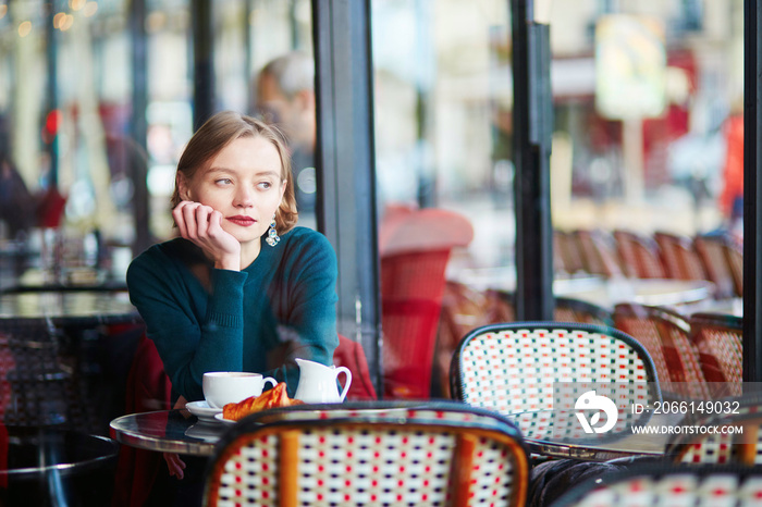 Young elegant woman drinking coffee in cafe in Paris, France