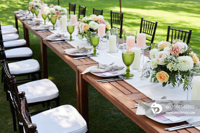 chairs and dinner tables with white cloth, served with porcelain and green glasses. Georgeous event 