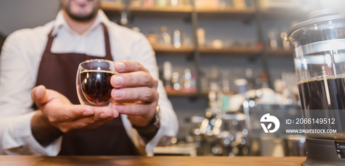 Closeup startup small business owner man hand holding espresso cup in coffee shop. Portrait of young