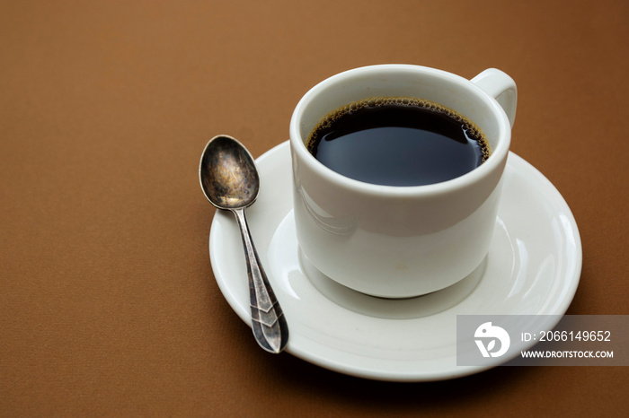 Coffee cup isolated on brown table. Coffee drink with copy space.