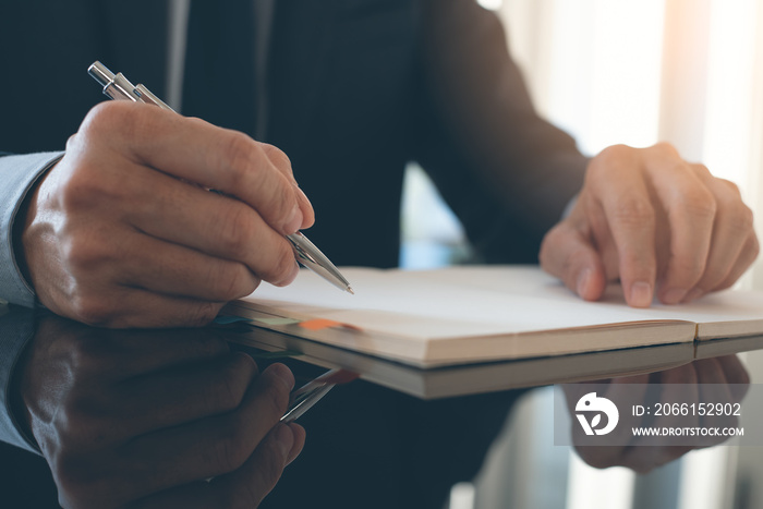 Businessman writing on notebook