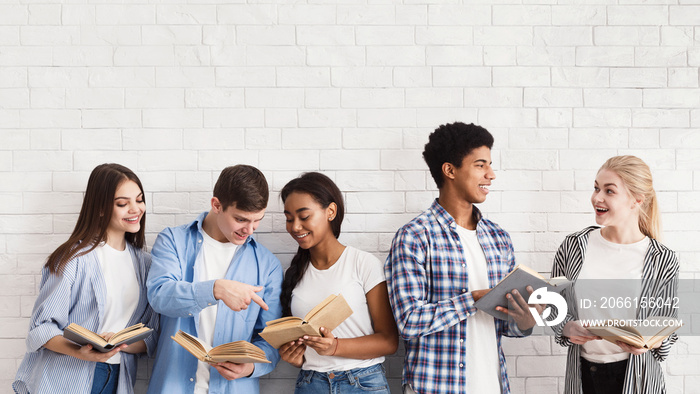 Exam preparation. Teenagers with books standing over light wall