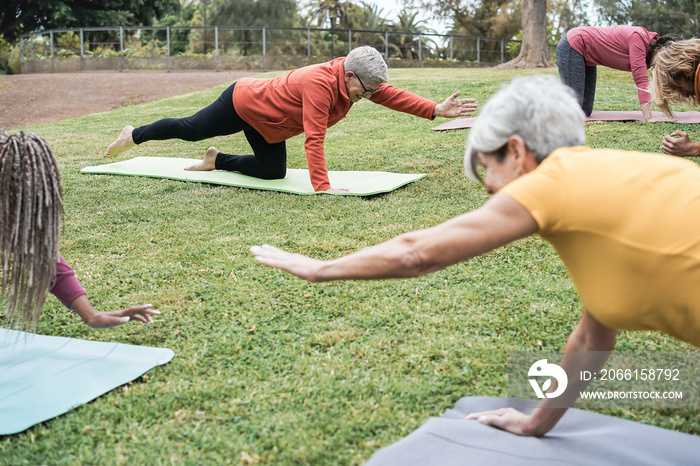 People doing yoga class while keeping social distance at city park - Main focus on middle woman face