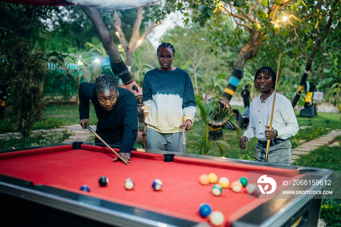 Queer masculine women playing pool