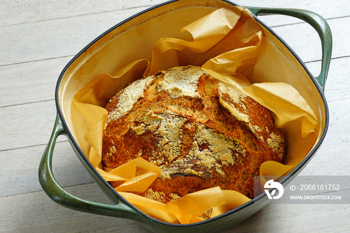 Loaf of crusty no-knead overnight bread baked in a Dutch oven