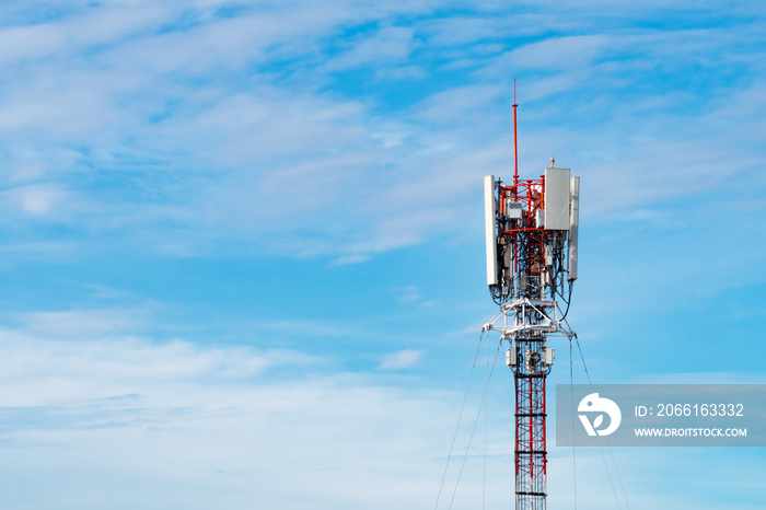 Telecommunication tower with blue sky and white clouds background. Antenna on blue sky. Radio and sa