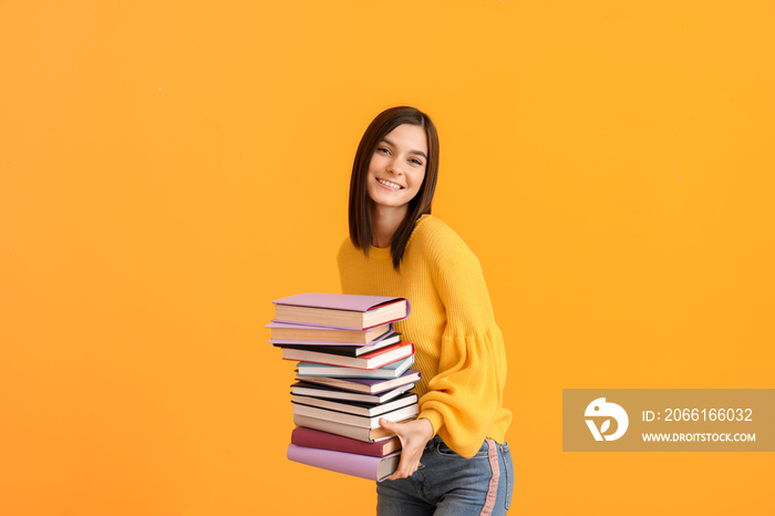 Beautiful young woman with many books on color background