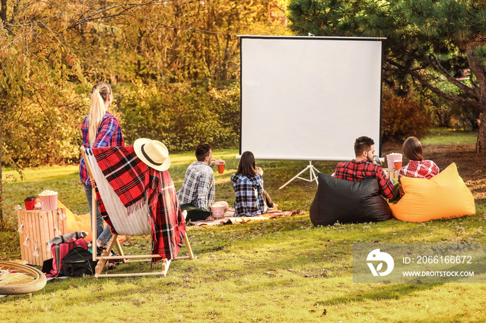 Friends watching movie in outdoor cinema