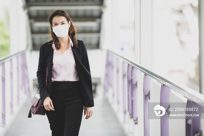 Woman wearing mask waking to work.