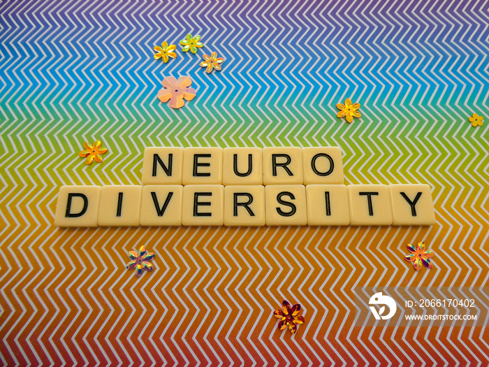 Bright rainbow zig zag pattern background sign with the word  NEURODIVERSITY  in text lettering, for