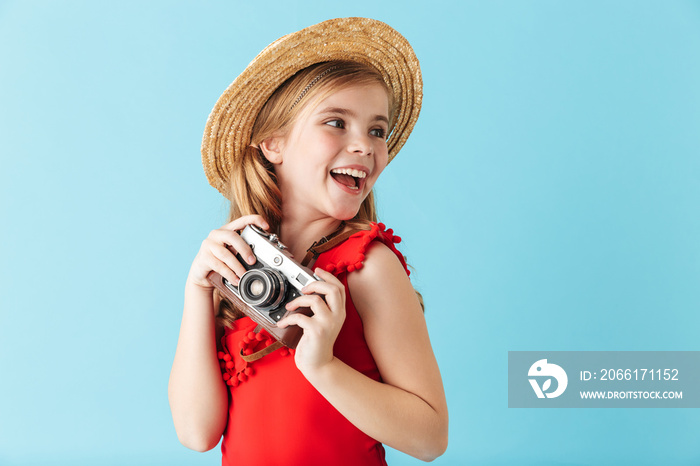 Cheerful little girl wearing swimsuit standing