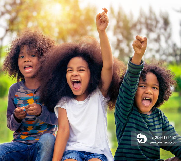 Happy African American boy and girl kids group playing in the playground in school. Children friends