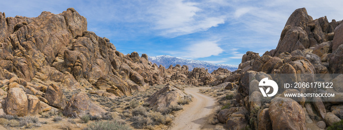 Dirt road leads into the massive boulders of Californias Alabama Hills.