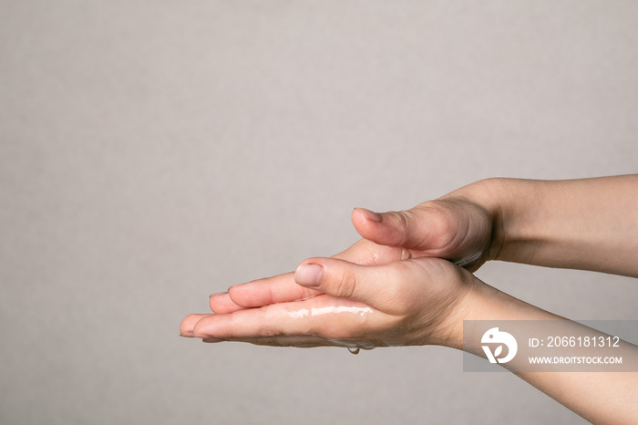 Child cleaning hands with antibacterial alcohol disinfectant