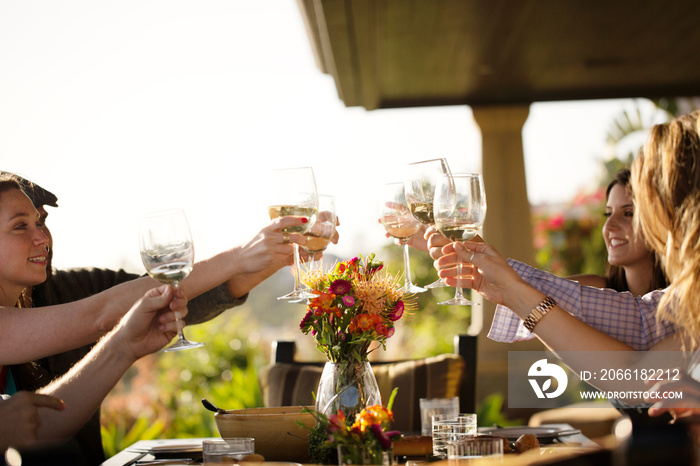 Friends toasting during lunch on patio